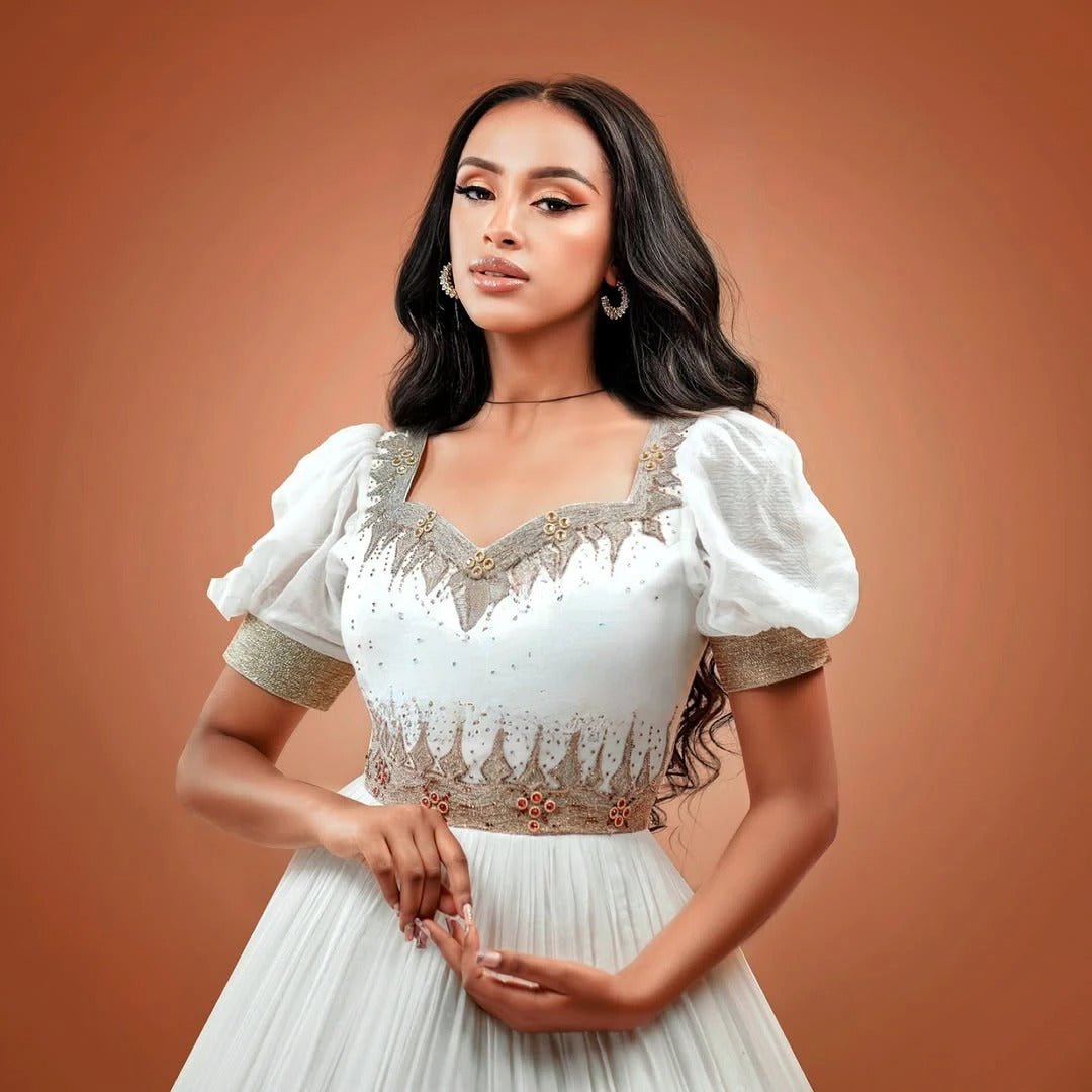 Gray Elegance Habesha Wedding Dress: Golden Floral Hemline Embroidery for Modern Brides
