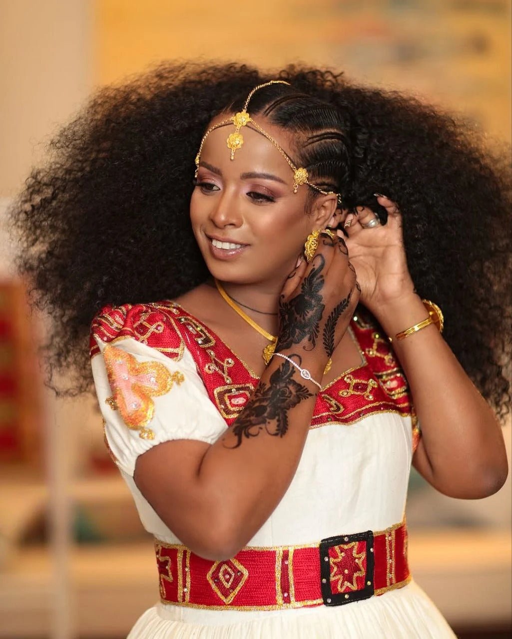 Elegant Habesha Couple's Attire with Vibrant Red and Gold Embroidery for Weddings