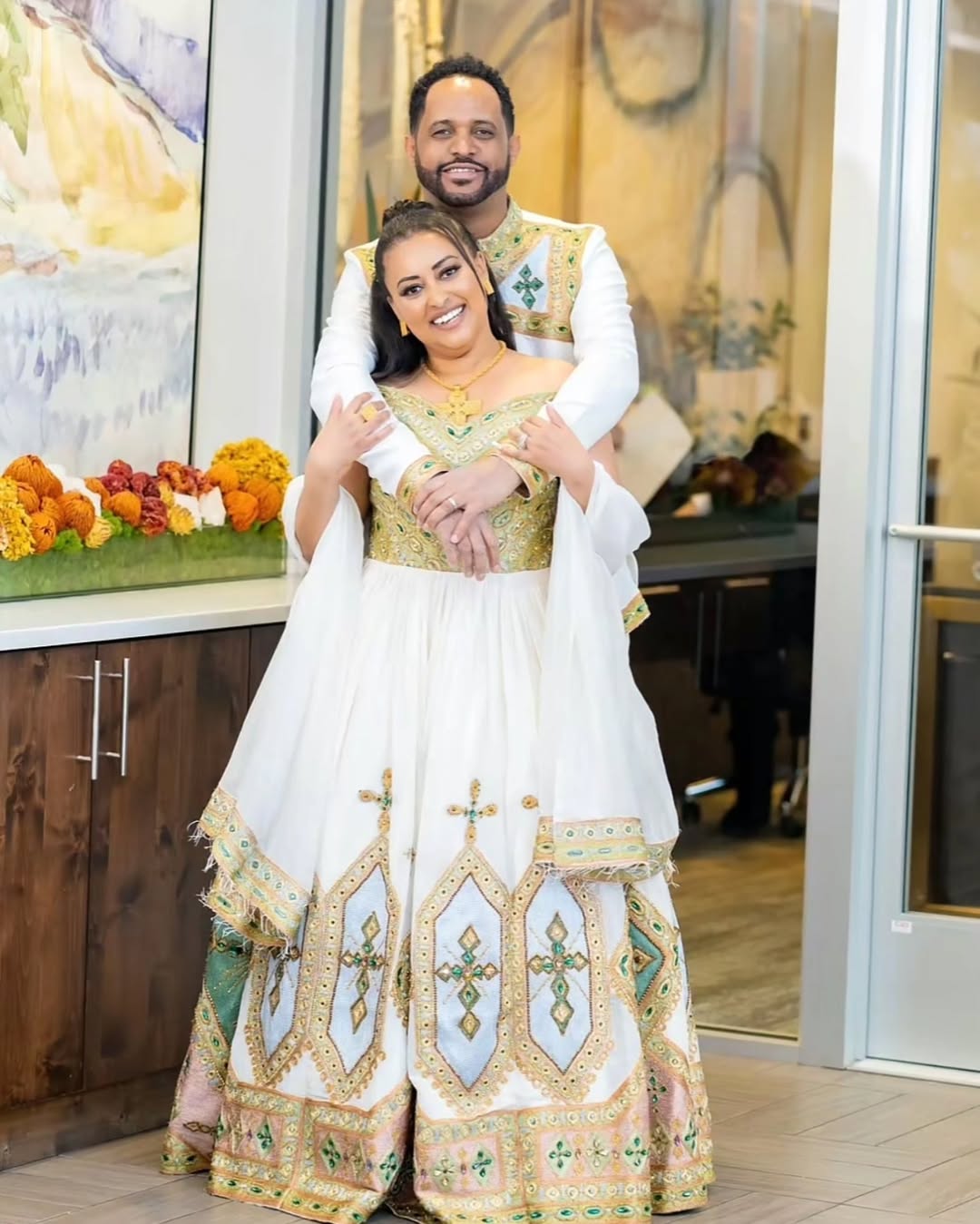 Couple's Distinctive Wedding: Golden Radiance Habesha Bridal Wear with Green Stitching