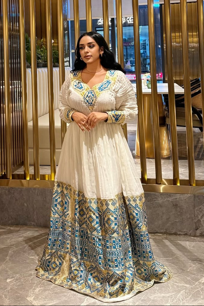 white blue and gold dress The Sammy La Maregold Experience the grandeur of tradition with our Stunning White Ethiopian Dress Stunning White Ethiopian Dress Adorned