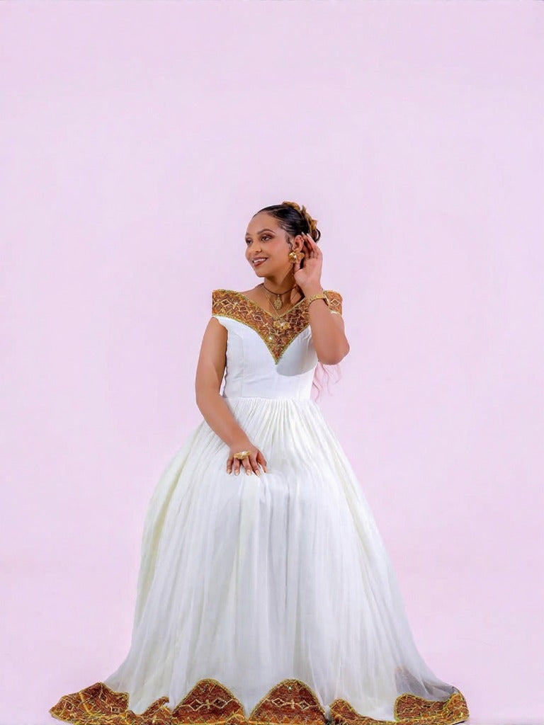Unique Habesha Kemis Design with Brown and Gold Geometric Accents for Wedding