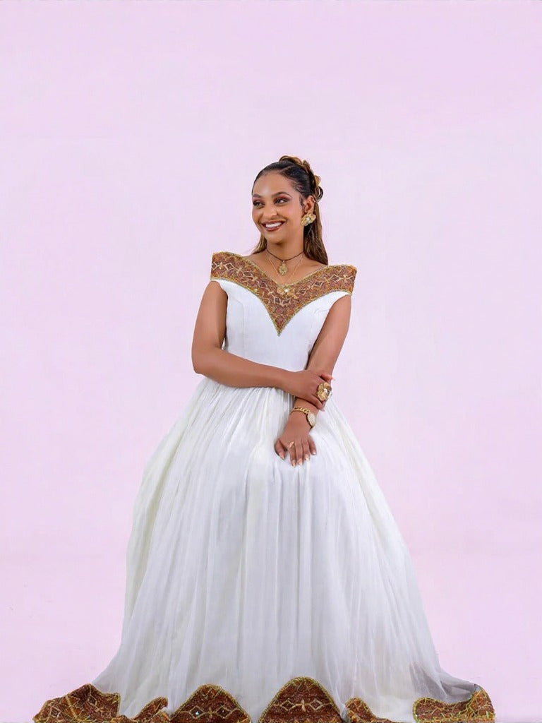 Unique Habesha Kemis Design with Brown and Gold Geometric Accents for Wedding