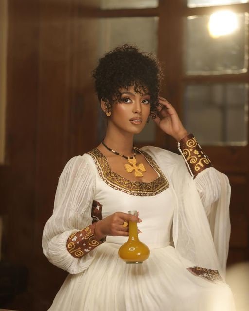 A Shimmering Modern Habesha Kemis with Full Shimena and Tilf