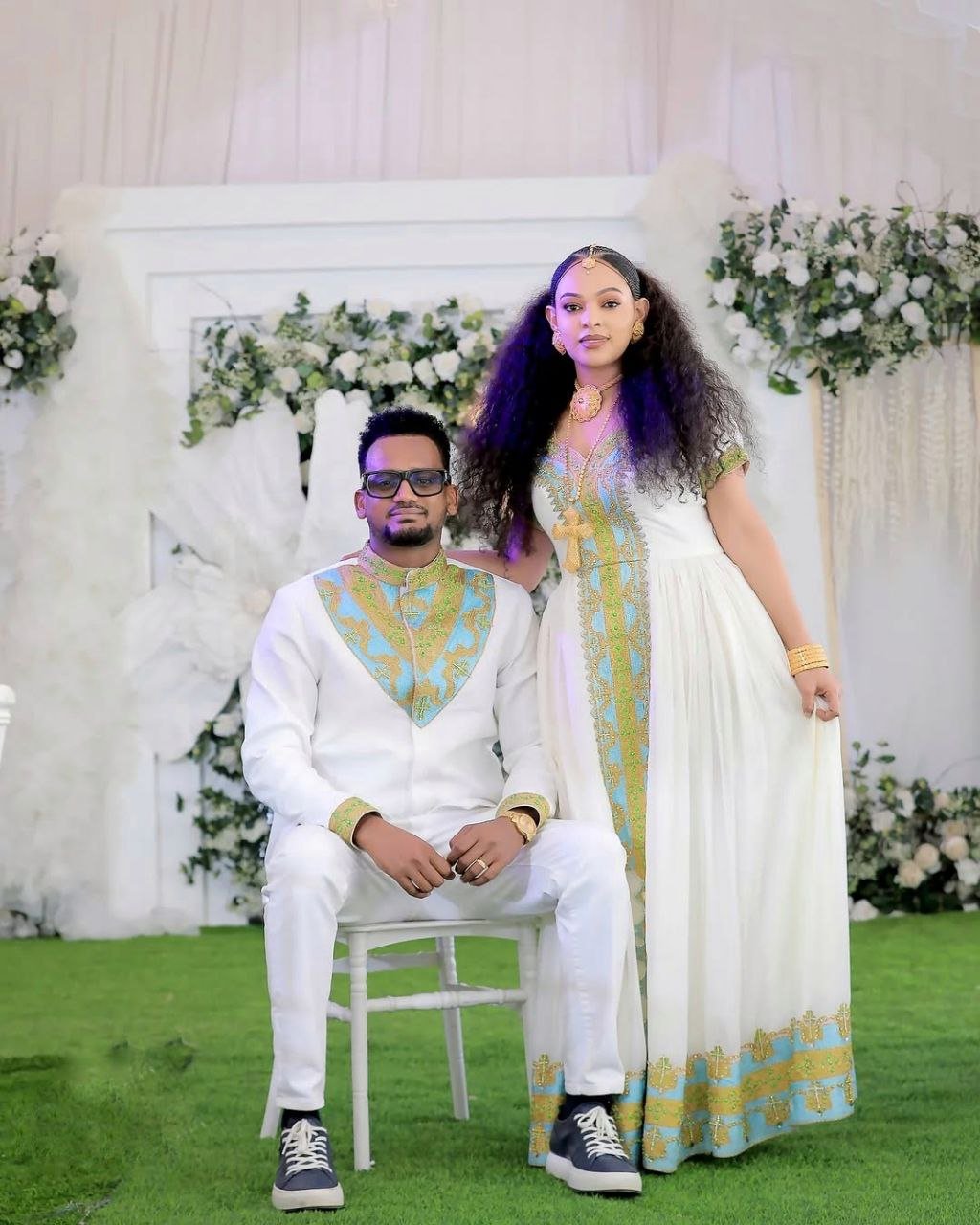 Regal Habesha Couple Outfit with Gold and Aqua Blue Wedding Dress and Matching Men’s Set for Traditional Ceremonies