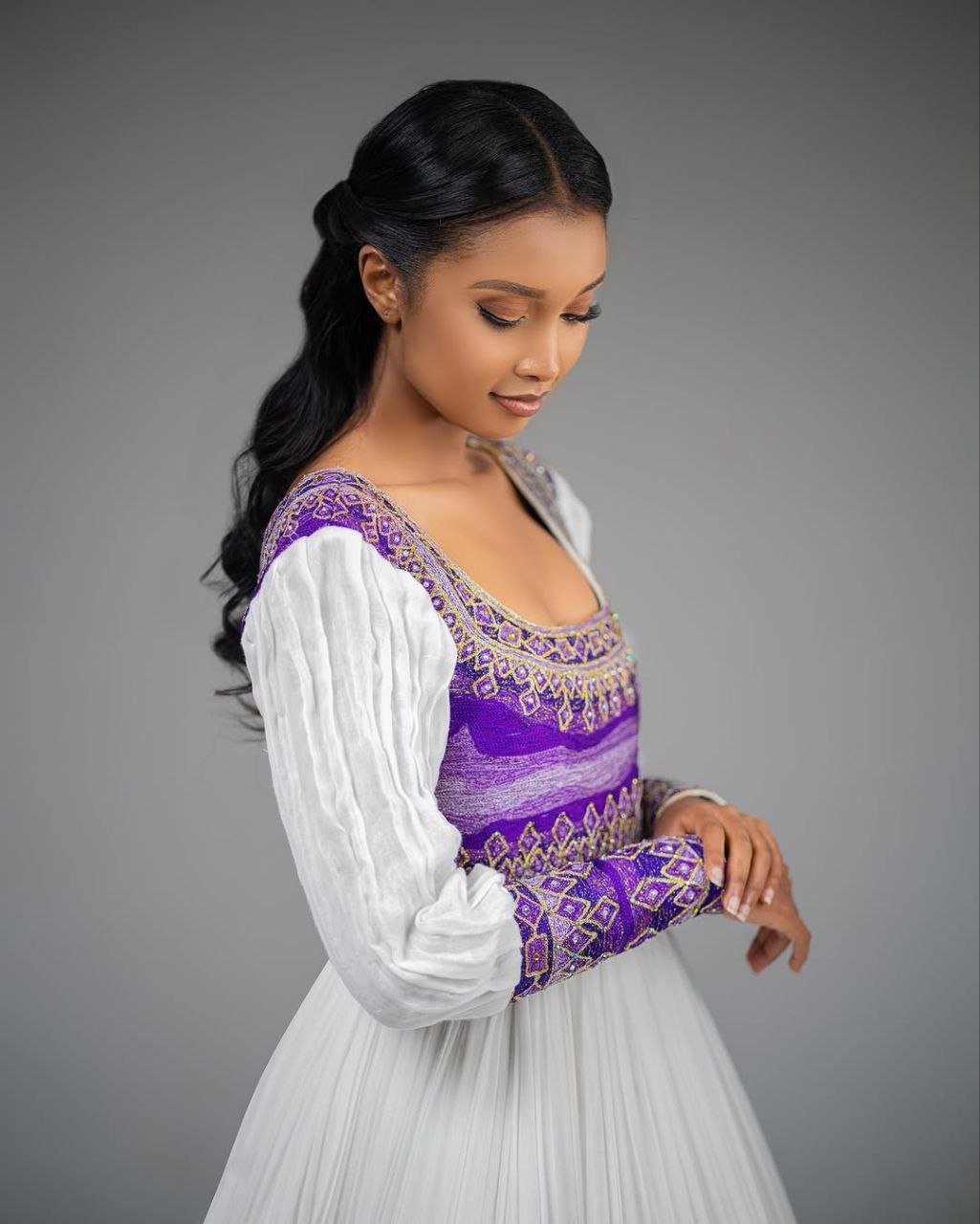Glamorous Habesha Dress with Intricate Purple Embroidery: A Beautiful Ethiopian Wedding Dress