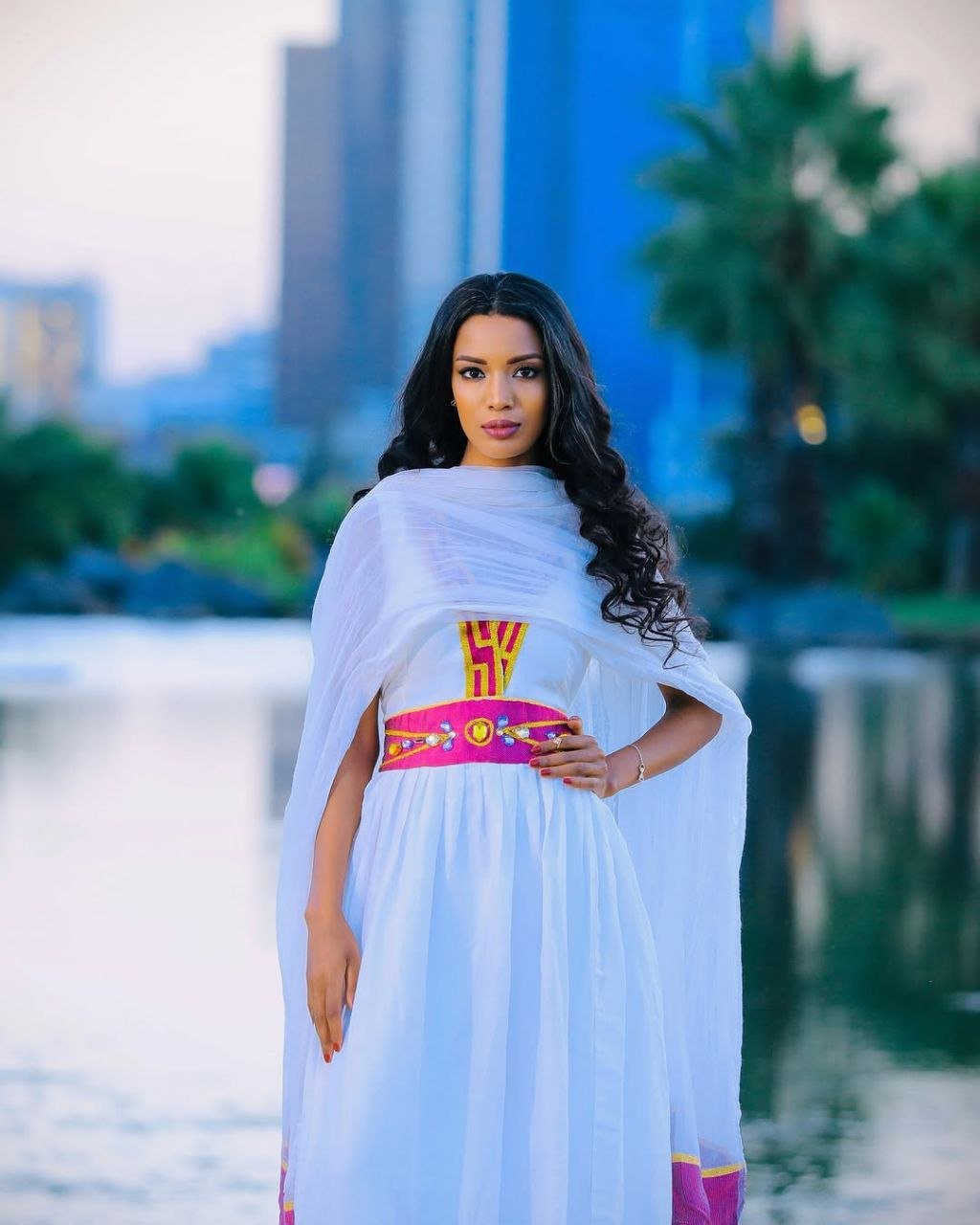 Simple Habesha Dress with Vibrant Pink and Gold Embroidery for Special Occasions