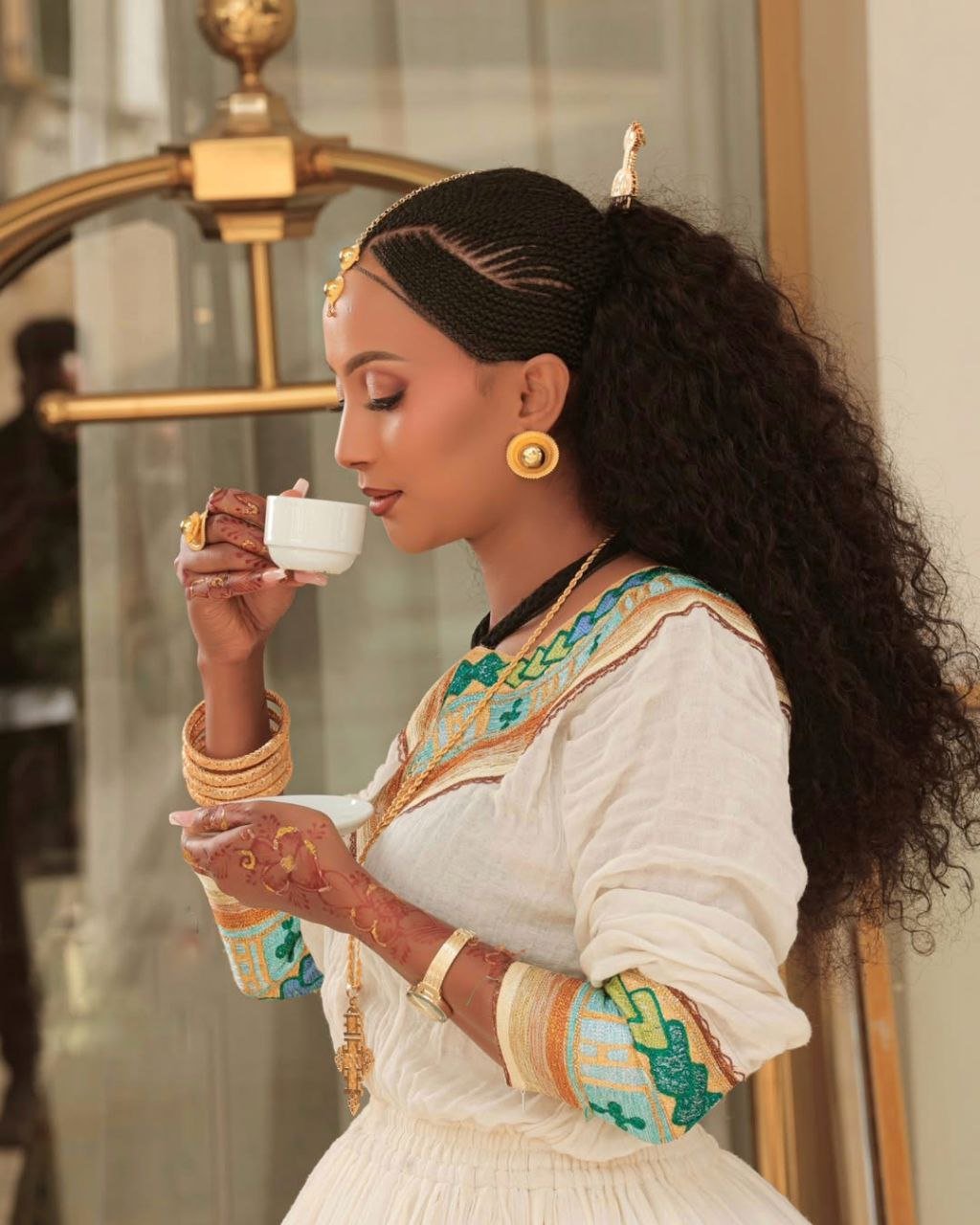 Chic Habesha Couple's Attire with Colorful Embroidery for Celebrations