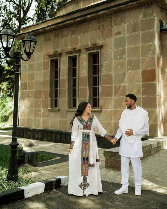Modern Traditional Ethiopian Couple Outfit – Multicolor Embroidered Habesha Kemis & Men's White Suit