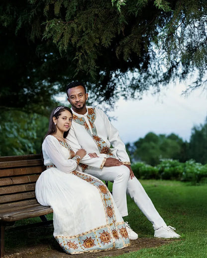 Fondling Love in Light Blue Habesha Couples Outfit: with Golden Circular Detailing Matching Ethiopian Couples Outfit