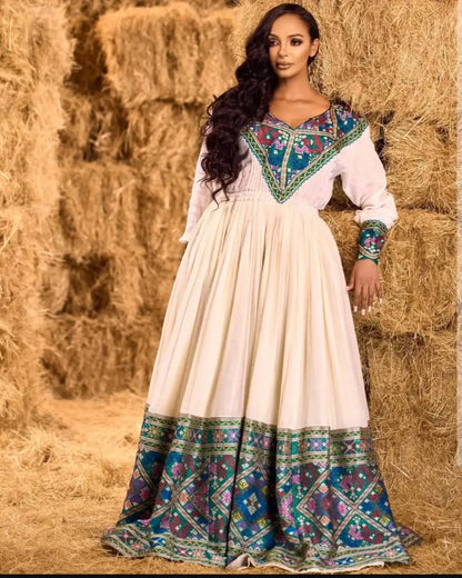 Regal Beauty with Blue Ethiopian Dress: Purple Detailing on Traditional Eritrean Dress Beautiful Colorful Habesha Dress