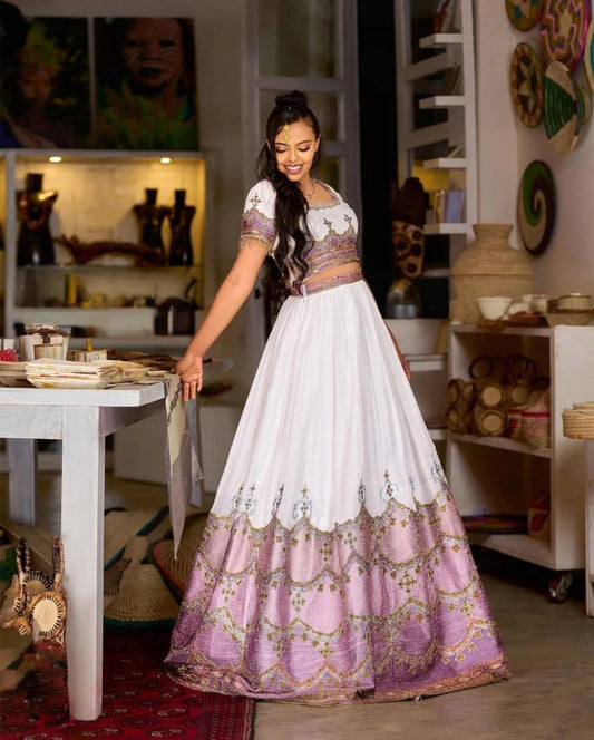 Stunning Ethiopian Traditional Wedding Dress in Lavender with Intricate Gold Detailing
