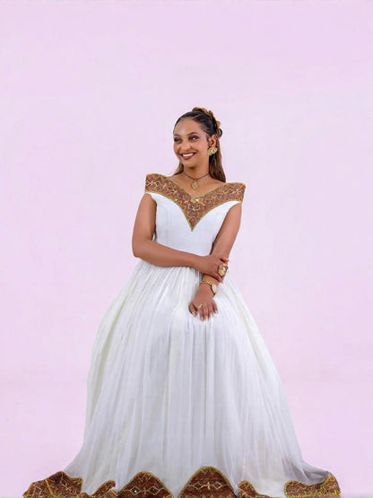 Unique Habesha Kemis Design with Brown and Gold Geometric Accents for Wedding