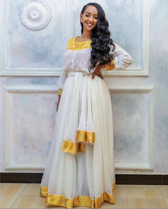 Coral Habesha Dress – Modern Flowing A-Line with Gold Tibeb Accents