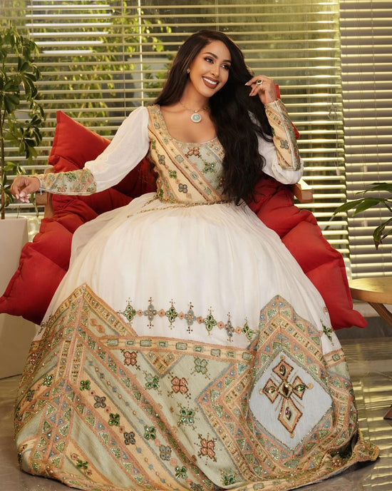 Graceful Habesha Wedding Dress in Blush with Golden Embroidery & Hand-Stitched Red Borders