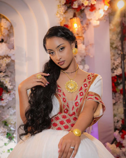 Modern Habesha Wedding Dress: Glowing in Radiant Red and Golden Embroidery