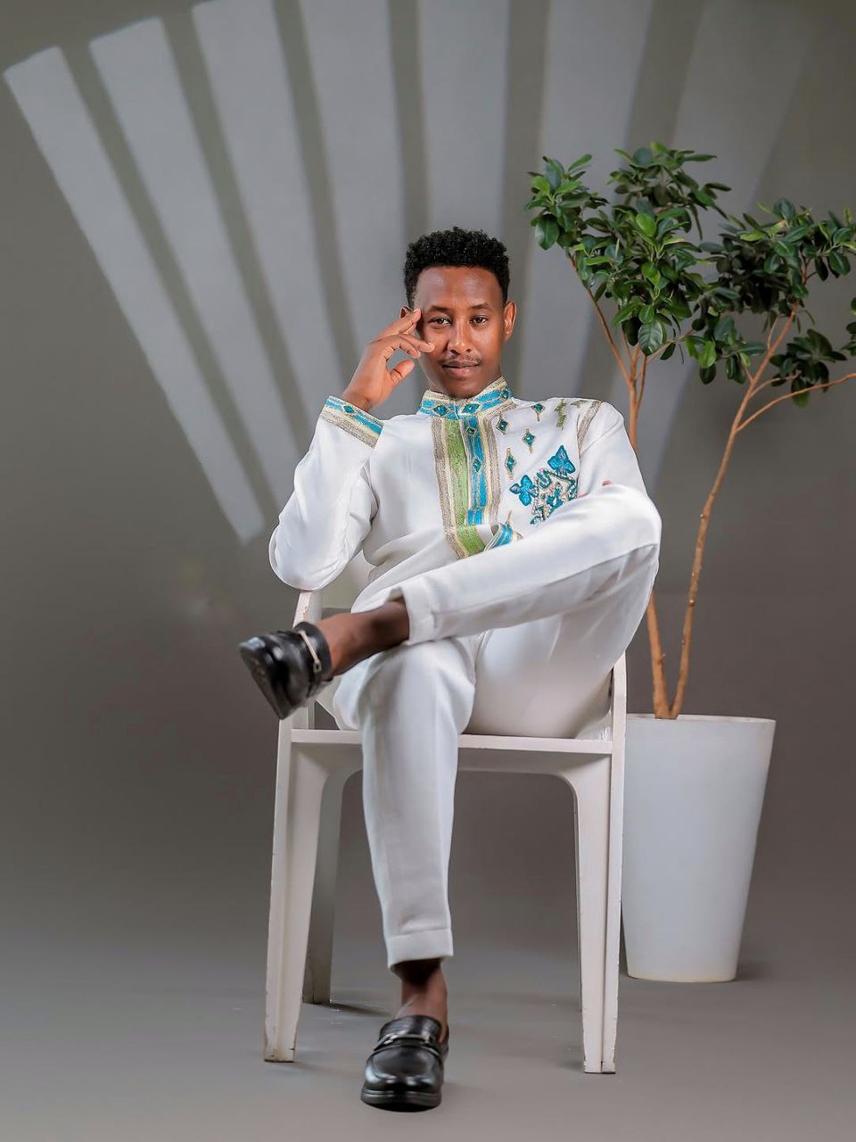 Elegant Ethiopian Men’s Outfit with Blue and Green Cross Motifs for Celebrations