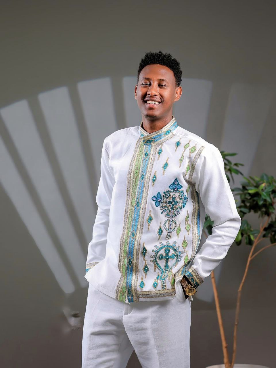 Elegant Ethiopian Men’s Outfit with Blue and Green Cross Motifs for Celebrations