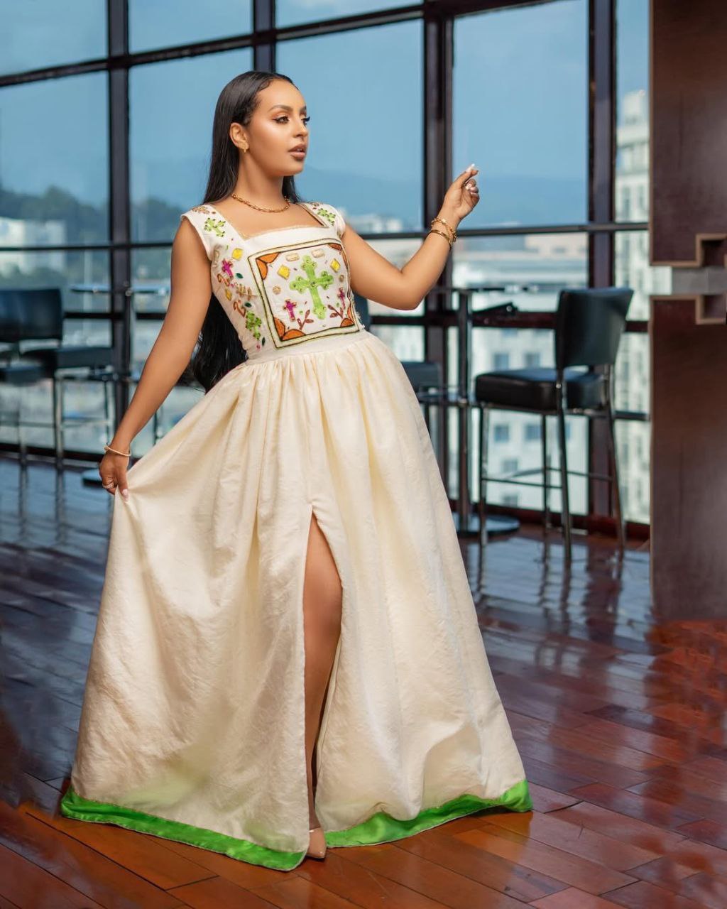 Elegant Sleeveless Modern Habesha Dress with Colorful Embroidered Bodice and Green Hem Perfect For Special Festivals
