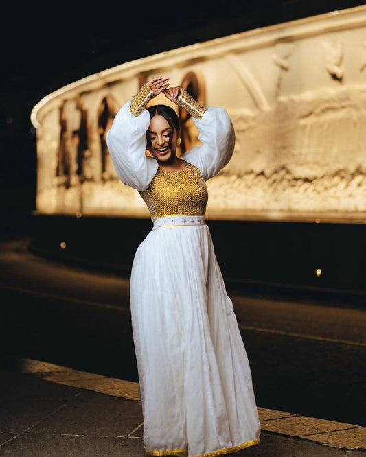  Vibrant Gold Bodice Habesha Dress with Flowing Skirt for an event
