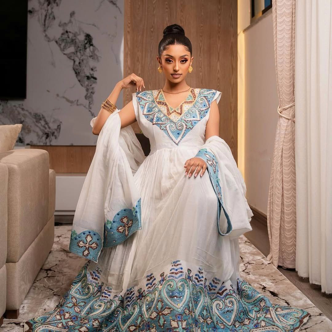 Elegant Habesha Kemis with Blue Embroidery and Royal Shoulder Detail for Weddings and Ceremonies
