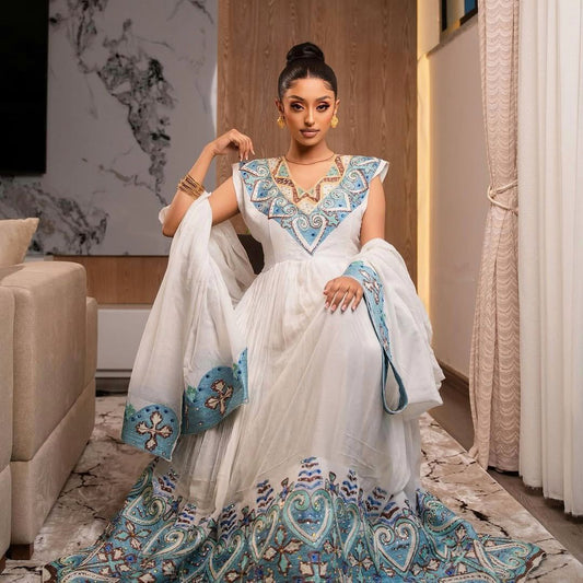 Elegant Habesha Kemis with Blue Embroidery and Royal Shoulder Detail for Weddings and Ceremonies
