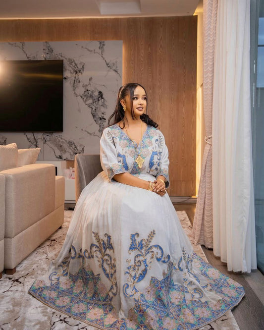 Graceful Habesha Kemis with Pastel Blue and Gold Embroidery for Engagements and Celebrations

