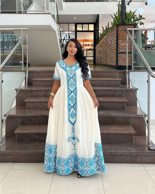 Elegant Habesha Dress with Striking Light Blue Embroidery for Cultural Events
