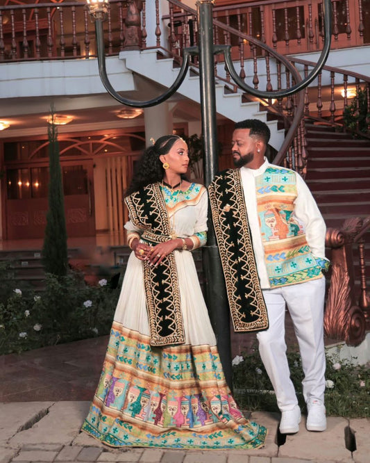 Chic Habesha Couple's Attire with Colorful Embroidery for Celebrations
