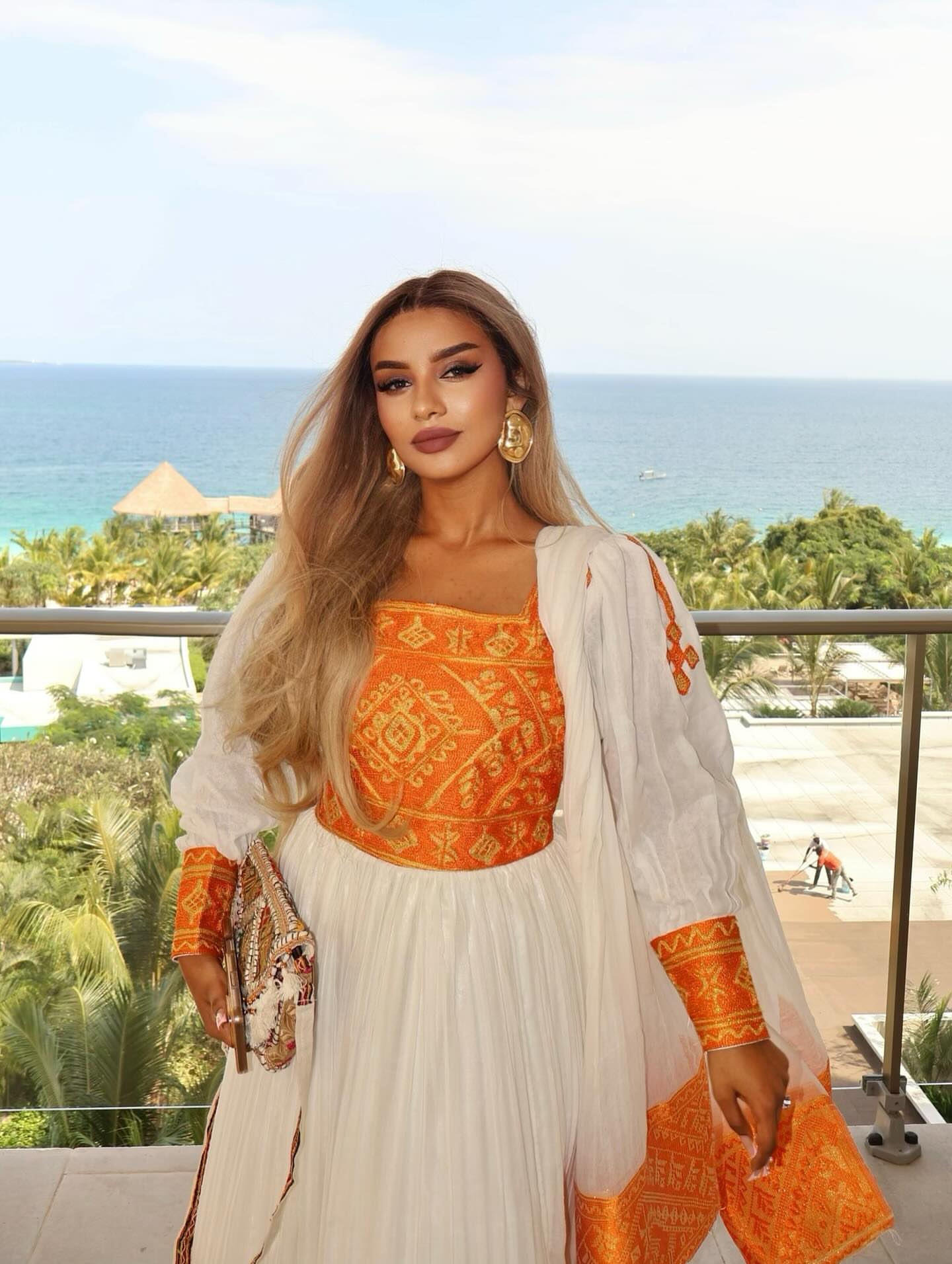 Elegant Habesha Kemis with Vibrant Orange Embellishments for Special Occasions