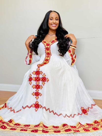 elegant white habesha dress with red and gold tibeb embroidery