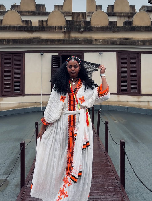 Traditional White Ethiopian Dress with Orange Tibeb Patterns