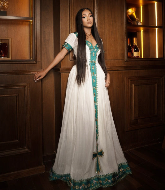 White Habesha dress with short sleeves featuring elegant green woven embroidery