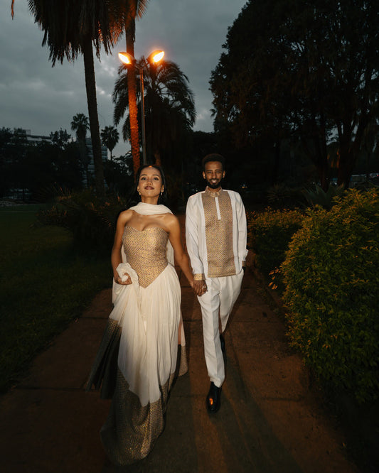 Elegant Ethiopian Couple in Gold and White Traditional Outfits