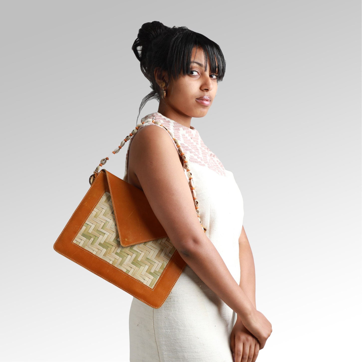 Yewubdar - Ethiopian slim shoulder bag handmade from bamboo, high quality leather, handwoven fabric, and shells by Tenadam
